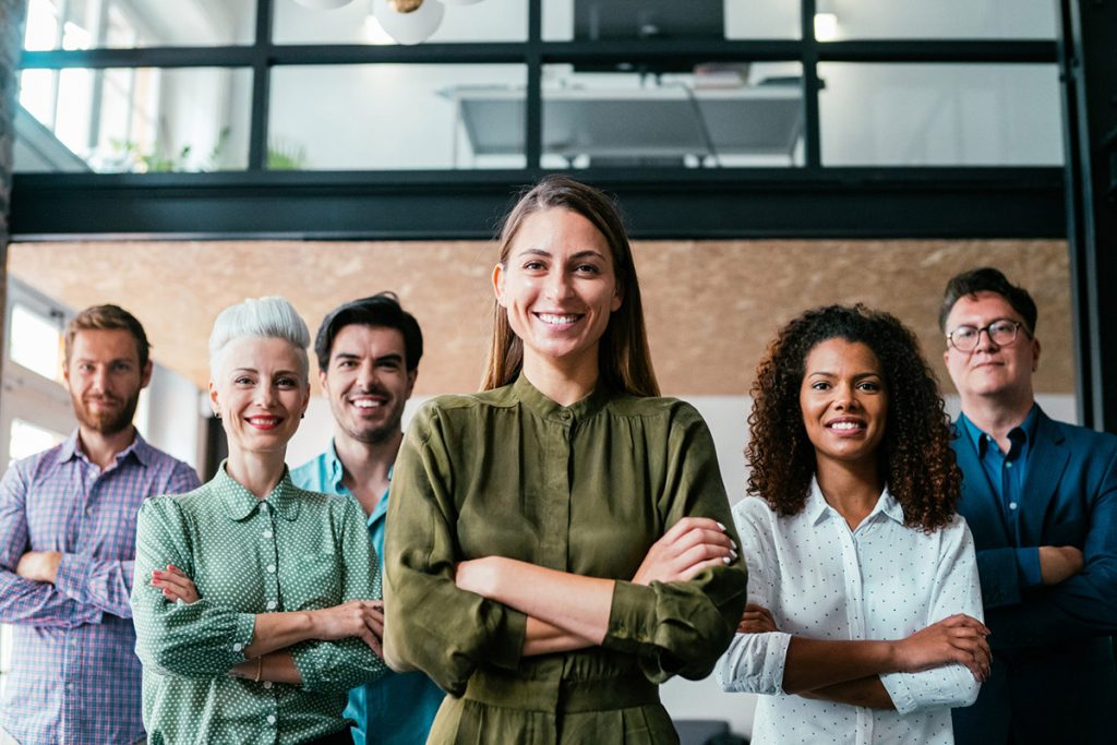 Team of men and woman with their arms folded